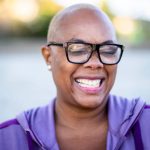 a beautiful black woman smiling during her workout.